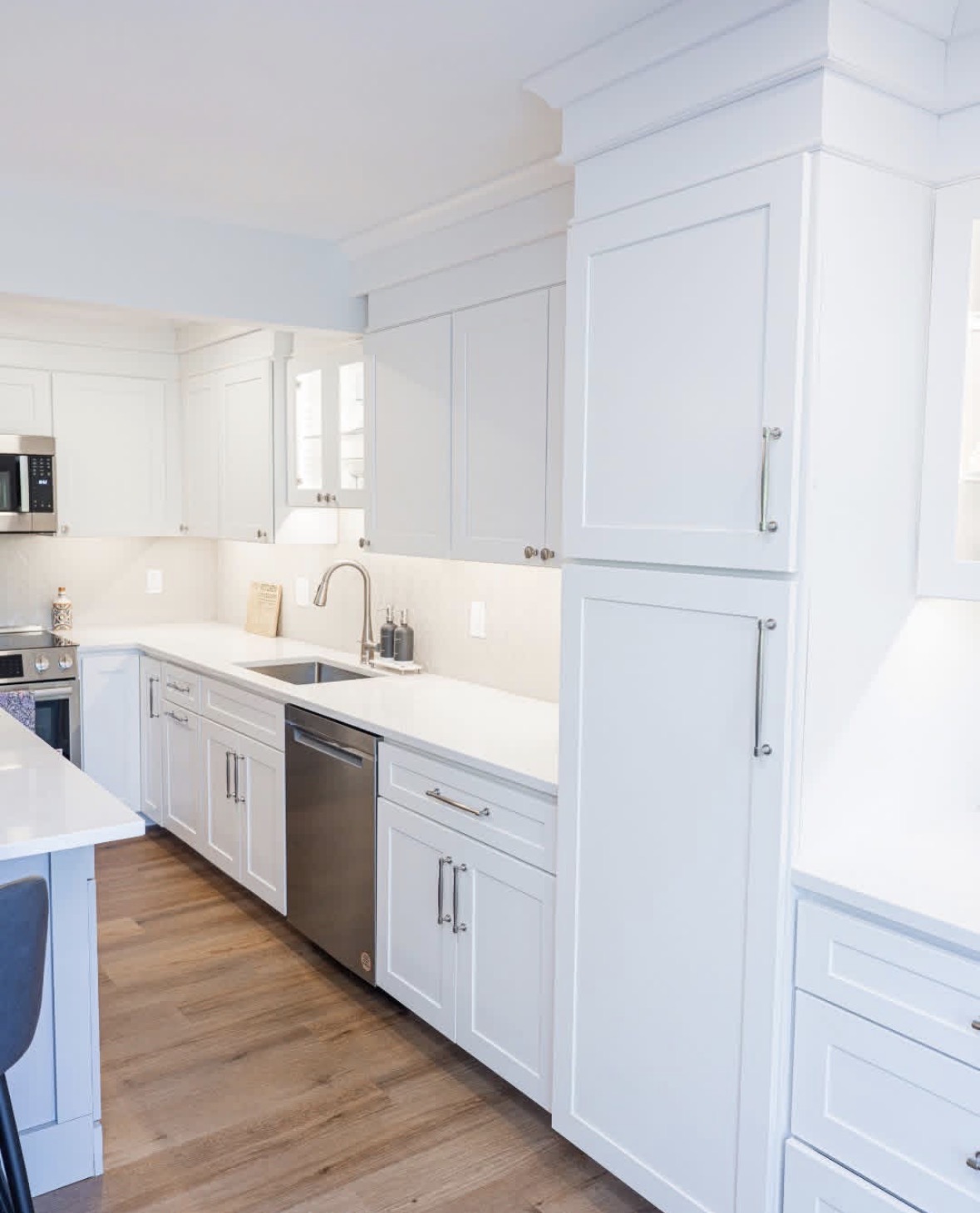 New white cabinetry, sink, and dishwasher